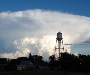 Water tower with thunderhead behind it